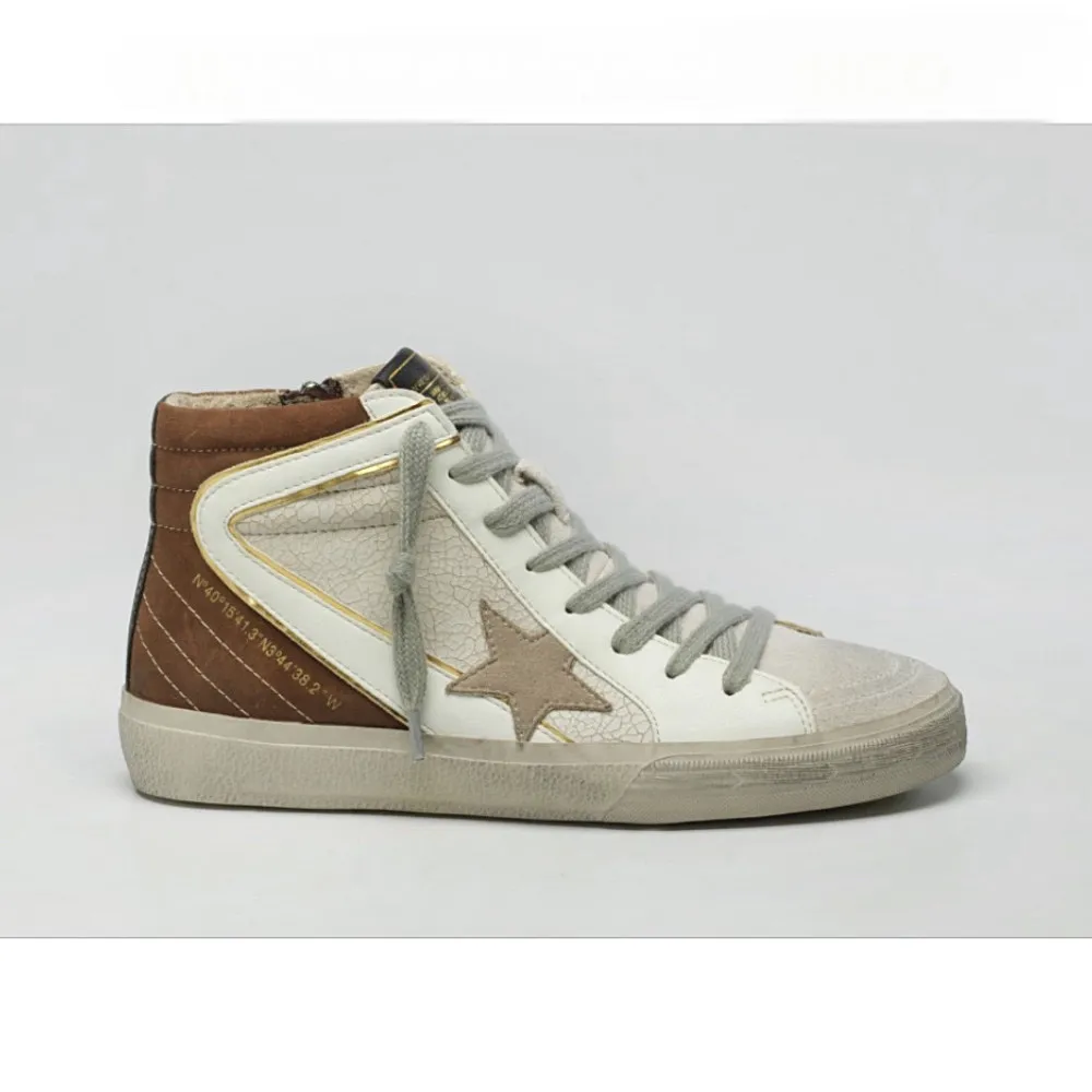 Corina white leather high-top sneakers with stars.